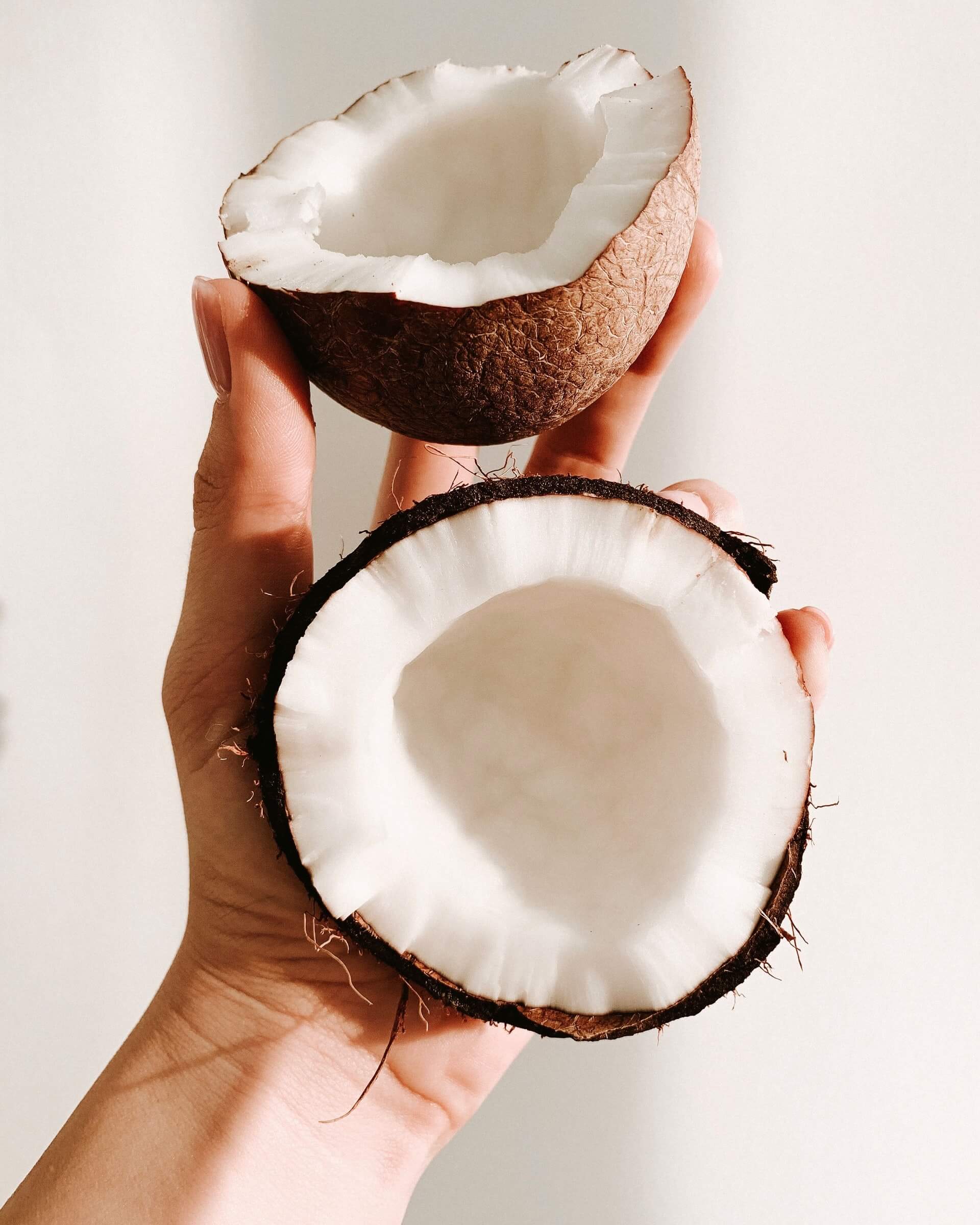 Opened coconut in a hand